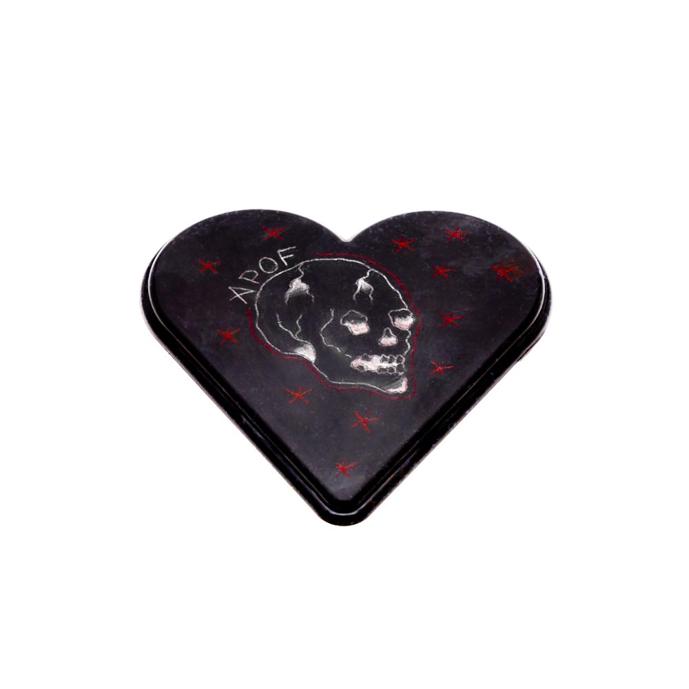 Example of black APOF Micro Heart canvas tattooed with white tattoo ink and red tattoo ink. Tattooed image shows white APOF letters, white skull, and red stars.